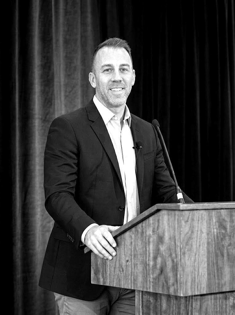Josh Dempsey speaking at a podium